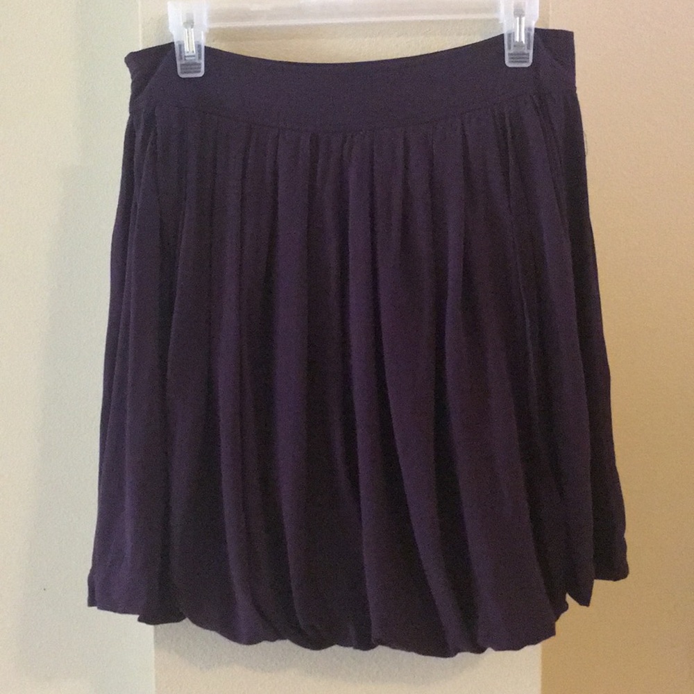 Deep purple pleated skirt.